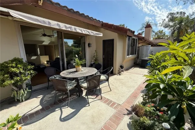 a view of a patio with table and chairs and potted plants