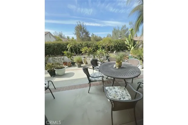 a balcony with table and chairs
