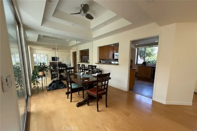 a view of a a dining room with furniture window and wooden floor