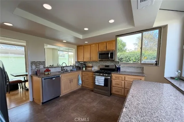 a kitchen with lots of counter top space and appliances