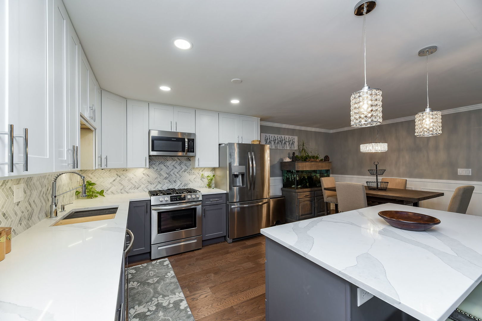 1122 Spring Garden Circle, Unit 2 Naperville, IL 60563 - Photo 3 of 10 a kitchen with stainless steel appliances granite countertop a sink a stove a refrigerator cabinets and chairs