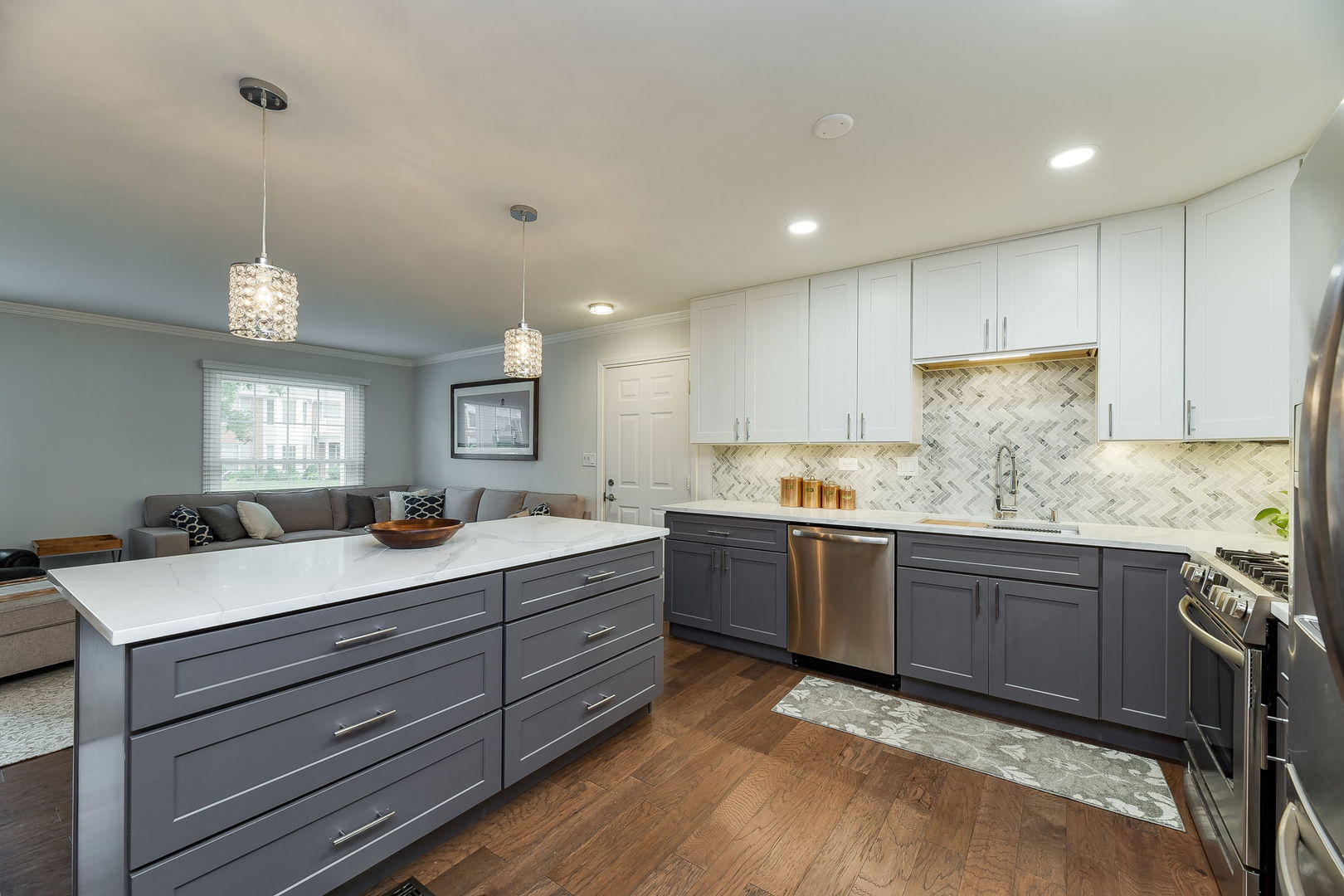 1122 Spring Garden Circle, Unit 2 Naperville, IL 60563 - Photo 4 of 10 a kitchen with kitchen island granite countertop a sink cabinets and stainless steel appliances
