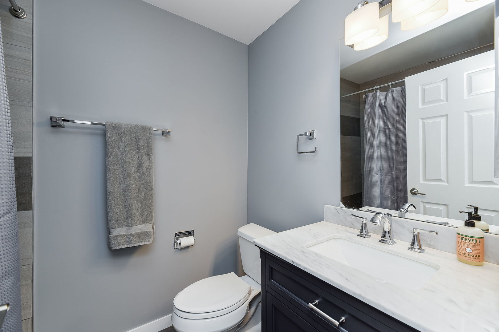 1122 Spring Garden Circle, Unit 2 Naperville, IL 60563 - Photo 6 of 10 a bathroom with a granite countertop sink a toilet a mirror and shower