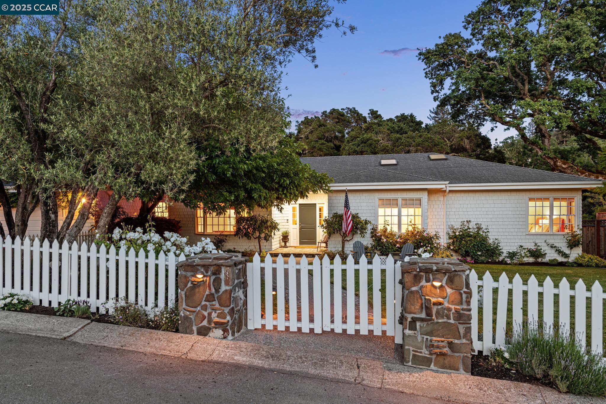 a front view of a house with a garden