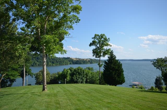 328 River Trace Road Dover, TN 37058 - Photo 4 of 30 a backyard of a house with lots of green space and lake view