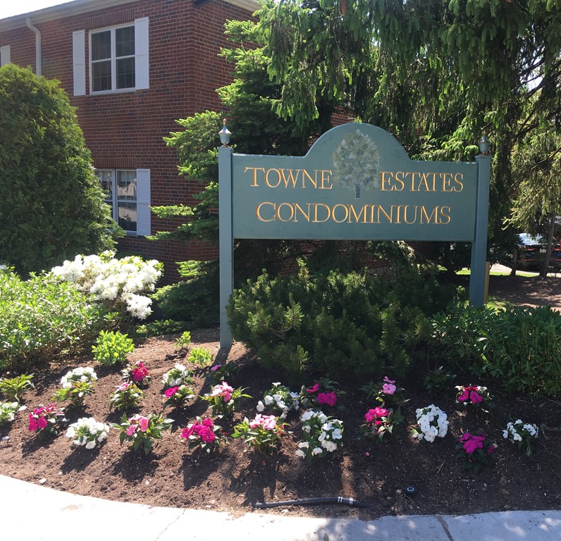 a sign that is in front of flowers