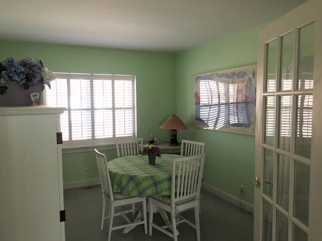 198 Lake Shore Road, Unit 2 Boston, MA 02135 - Photo 11 of 17 a dining room with furniture and a window