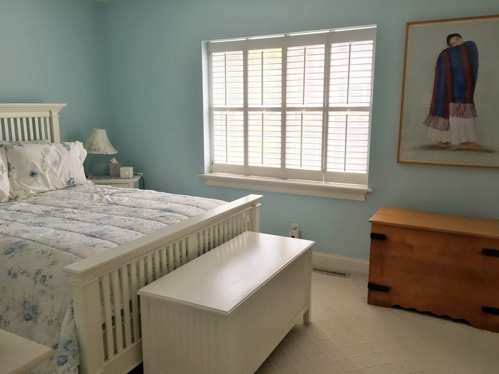 198 Lake Shore Road, Unit 2 Boston, MA 02135 - Photo 12 of 17 a bedroom with a bed and a window