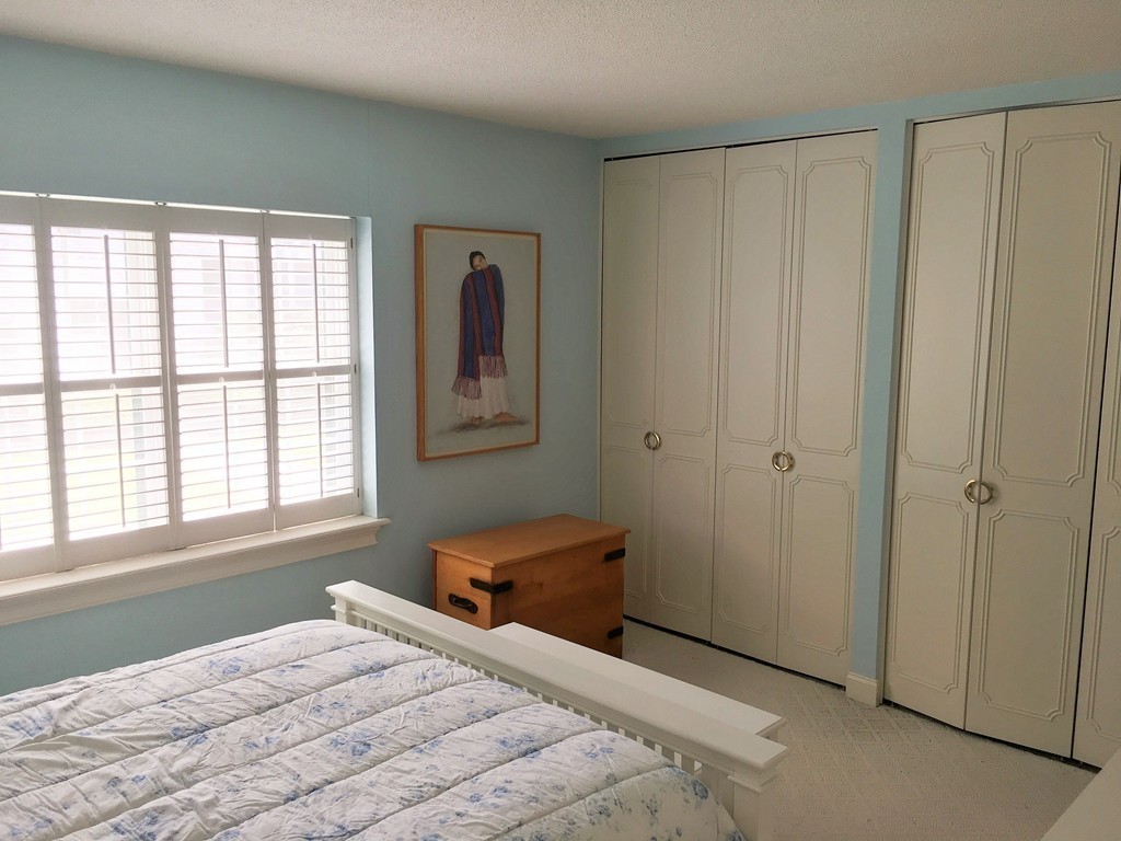 198 Lake Shore Road, Unit 2 Boston, MA 02135 - Photo 13 of 17 a bedroom with a bed and a window