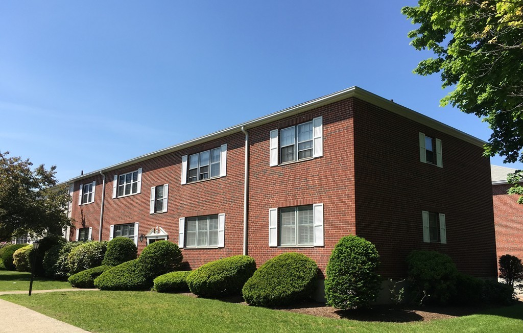198 Lake Shore Road, Unit 2 Boston, MA 02135 - Photo 2 of 17 a front view of a house with a yard