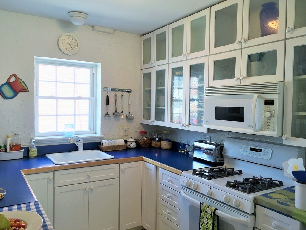 198 Lake Shore Road, Unit 2 Boston, MA 02135 - Photo 7 of 17 a kitchen with a stove a sink and a microwave