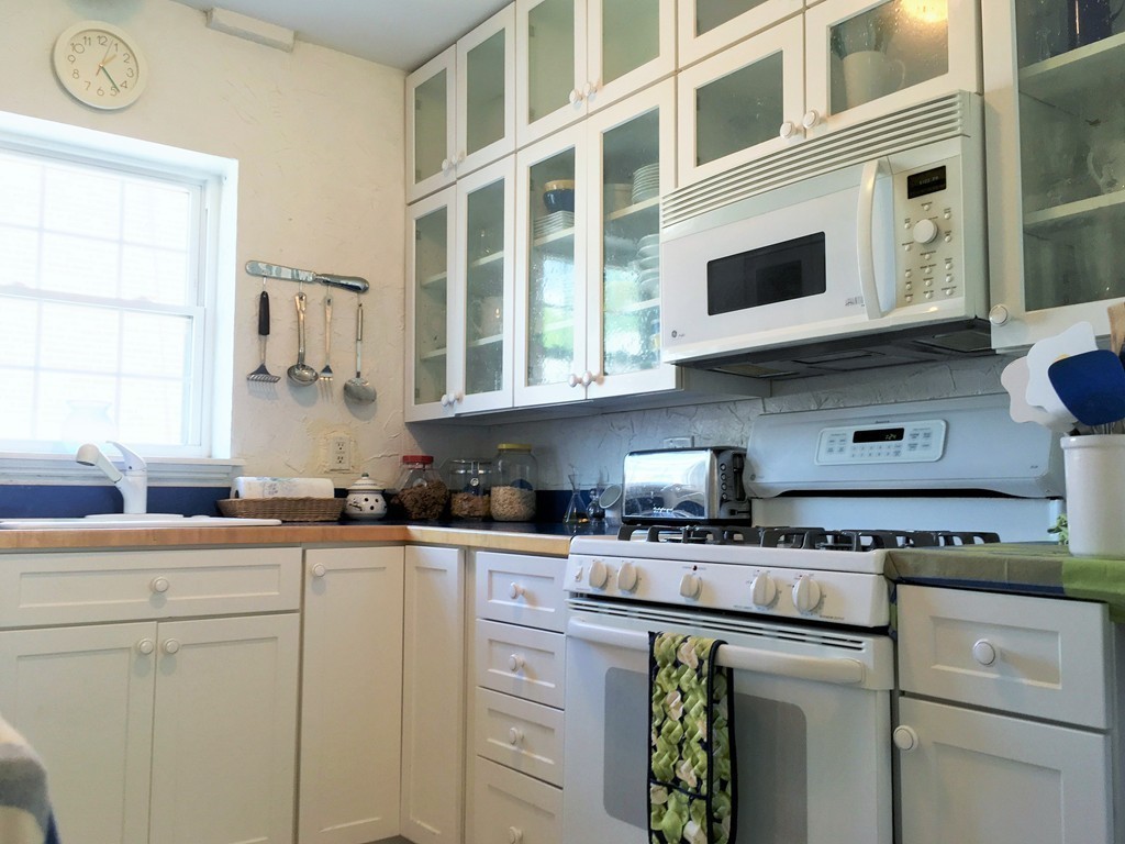 198 Lake Shore Road, Unit 2 Boston, MA 02135 - Photo 9 of 17 a kitchen with stainless steel appliances granite countertop a sink and cabinets
