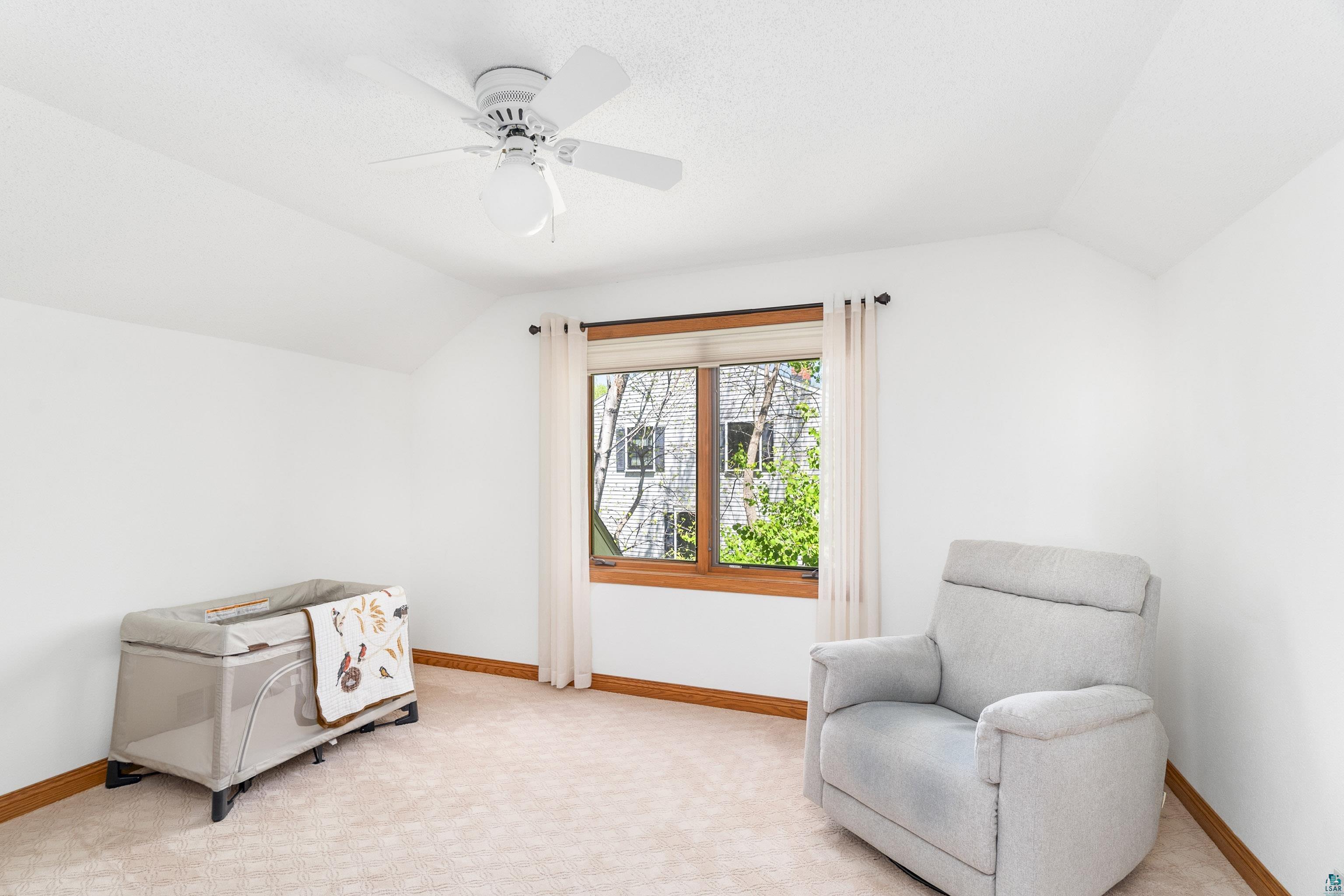 808 Ridgewood Road Duluth, MN 55804 - Photo 31 of 50 Sitting room featuring light carpet, ceiling fan, and vaulted ceiling