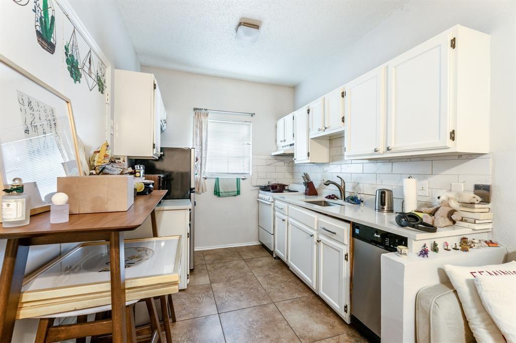 3206 King Street, Unit 206 Austin, TX 78705 - Photo 2 of 5 a kitchen with white cabinets and white appliances