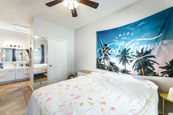 a bedroom with a large bed and a chandelier