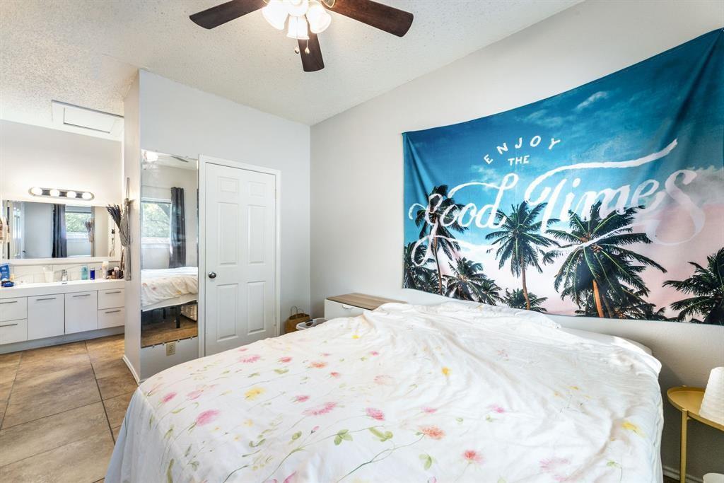 3206 King Street, Unit 206 Austin, TX 78705 - Photo 3 of 5 a bedroom with a large bed and a chandelier