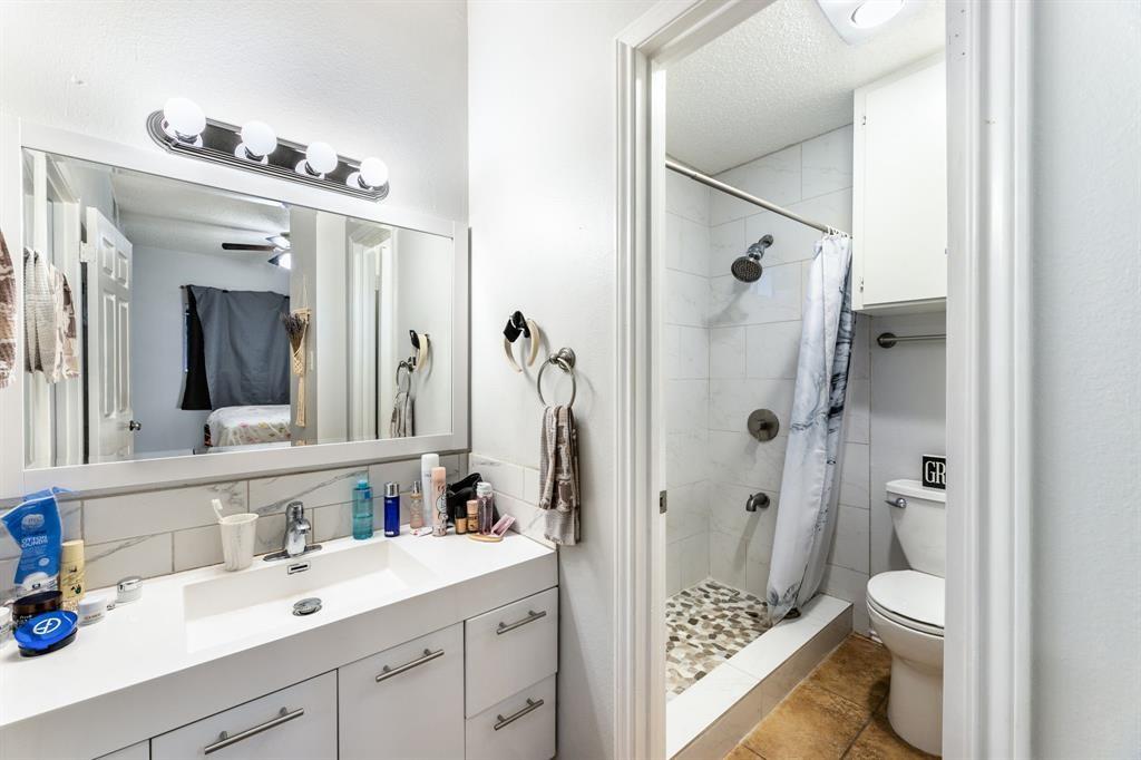 3206 King Street, Unit 206 Austin, TX 78705 - Photo 4 of 5 a bathroom with a double vanity sink mirror and shower