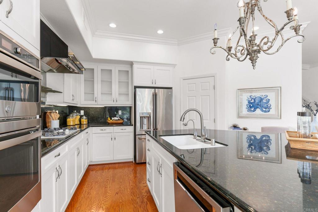 2738 MacKinnon Ranch Road Cardiff-by-the-Sea, CA 92007 - Photo 15 of 58 a kitchen with granite countertop a sink stainless steel appliances and cabinets