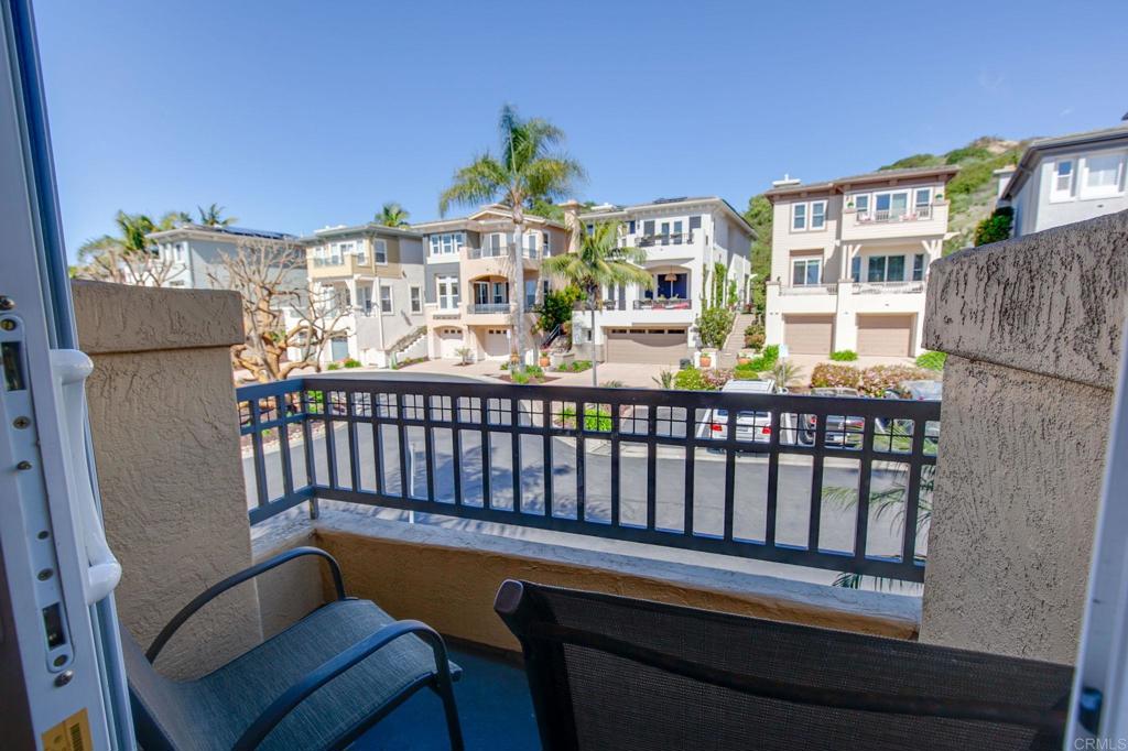 2738 MacKinnon Ranch Road Cardiff-by-the-Sea, CA 92007 - Photo 19 of 58 a balcony with table and chairs