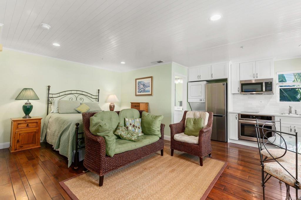 2738 MacKinnon Ranch Road Cardiff-by-the-Sea, CA 92007 - Photo 20 of 58 a bedroom with a bed and wooden floor