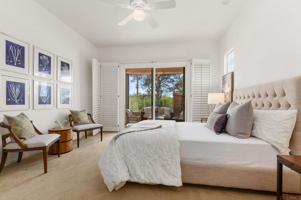 2738 MacKinnon Ranch Road Cardiff-by-the-Sea, CA 92007 - Photo 26 of 58 a bedroom with a bed a couch and large windows
