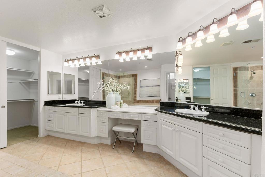2738 MacKinnon Ranch Road Cardiff-by-the-Sea, CA 92007 - Photo 28 of 58 a large white kitchen with granite countertop a sink and white cabinets