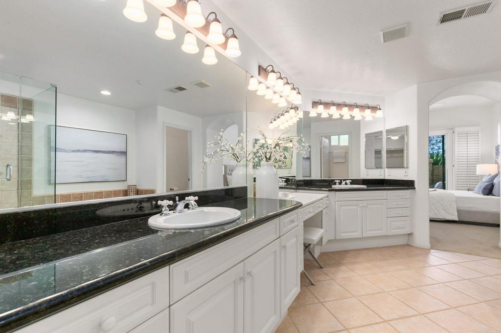 2738 MacKinnon Ranch Road Cardiff-by-the-Sea, CA 92007 - Photo 30 of 58 a large bathroom with a granite countertop sink a large mirror and a