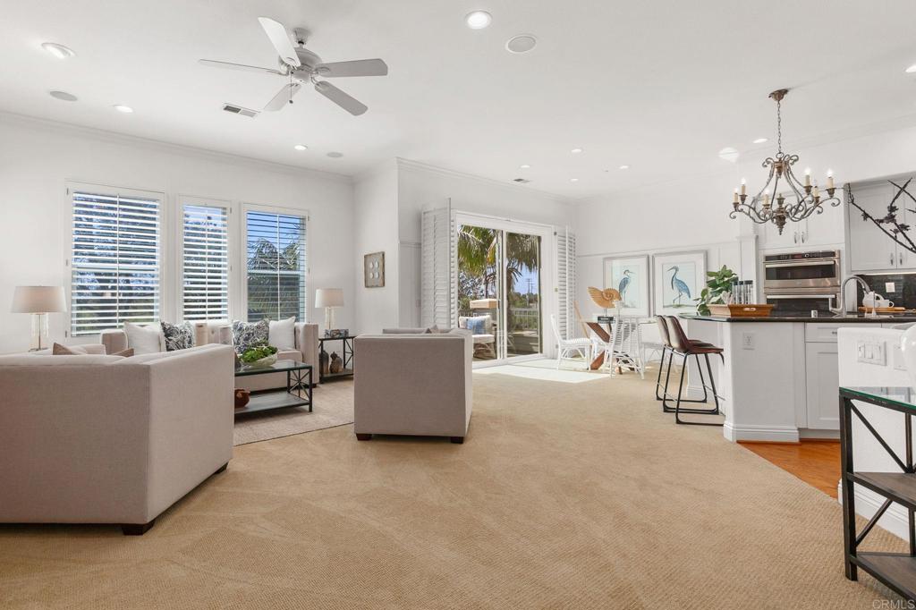 2738 MacKinnon Ranch Road Cardiff-by-the-Sea, CA 92007 - Photo 6 of 58 a living room with furniture and a chandelier