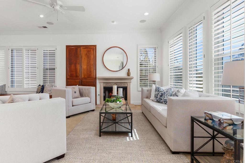2738 MacKinnon Ranch Road Cardiff-by-the-Sea, CA 92007 - Photo 8 of 58 a living room with furniture a fireplace and a large window