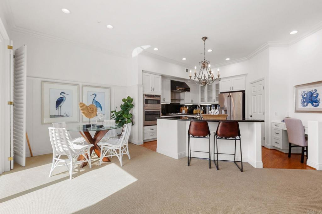 2738 MacKinnon Ranch Road Cardiff-by-the-Sea, CA 92007 - Photo 9 of 58 a view of a dining room with furniture and a chandelier