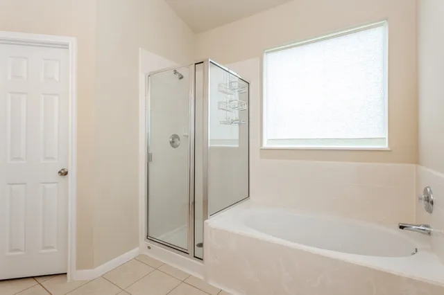 a white bath tub sitting next to a shower