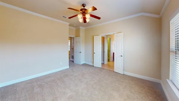 a view of a room with a ceiling fan and a window