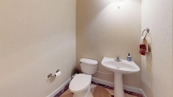 a bathroom with a sink mirror and toilet