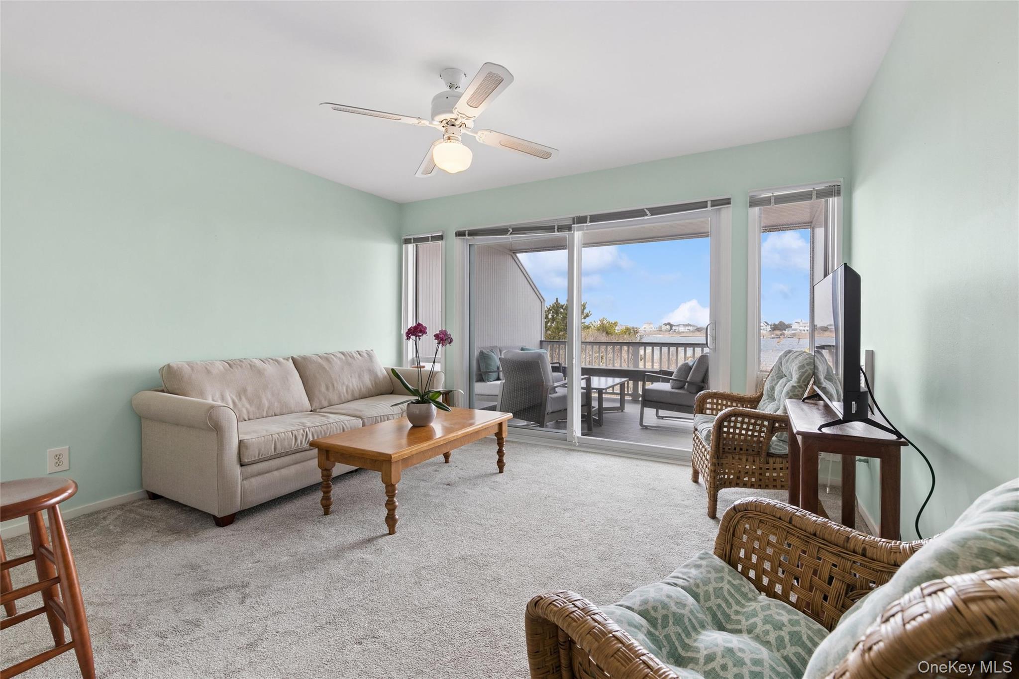 274 Dune Road, Unit 9 Westhampton Beach, NY 11978 - Photo 3 of 13 a living room with furniture and a large window