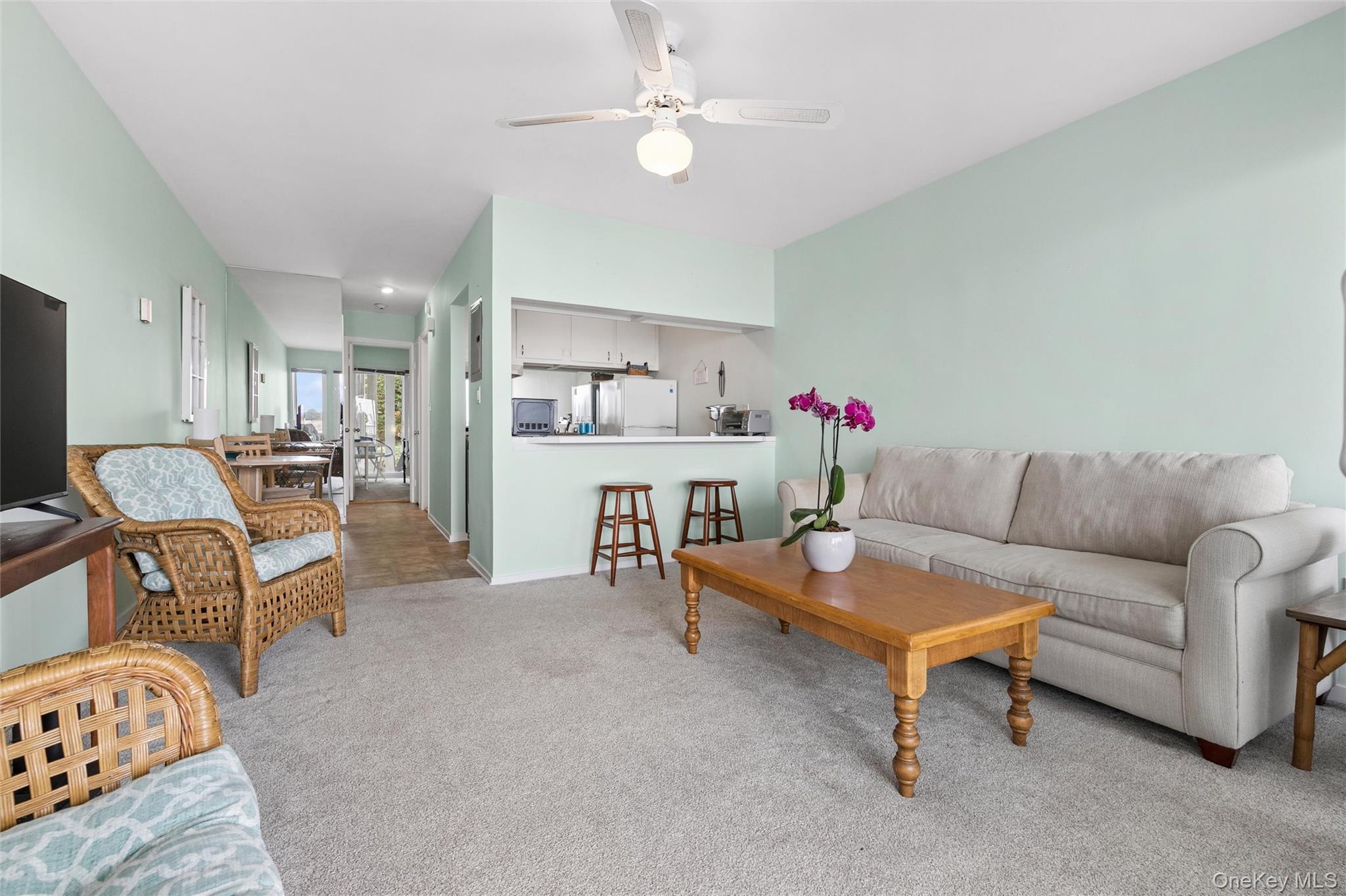 274 Dune Road, Unit 9 Westhampton Beach, NY 11978 - Photo 4 of 13 a living room with furniture and kitchen view