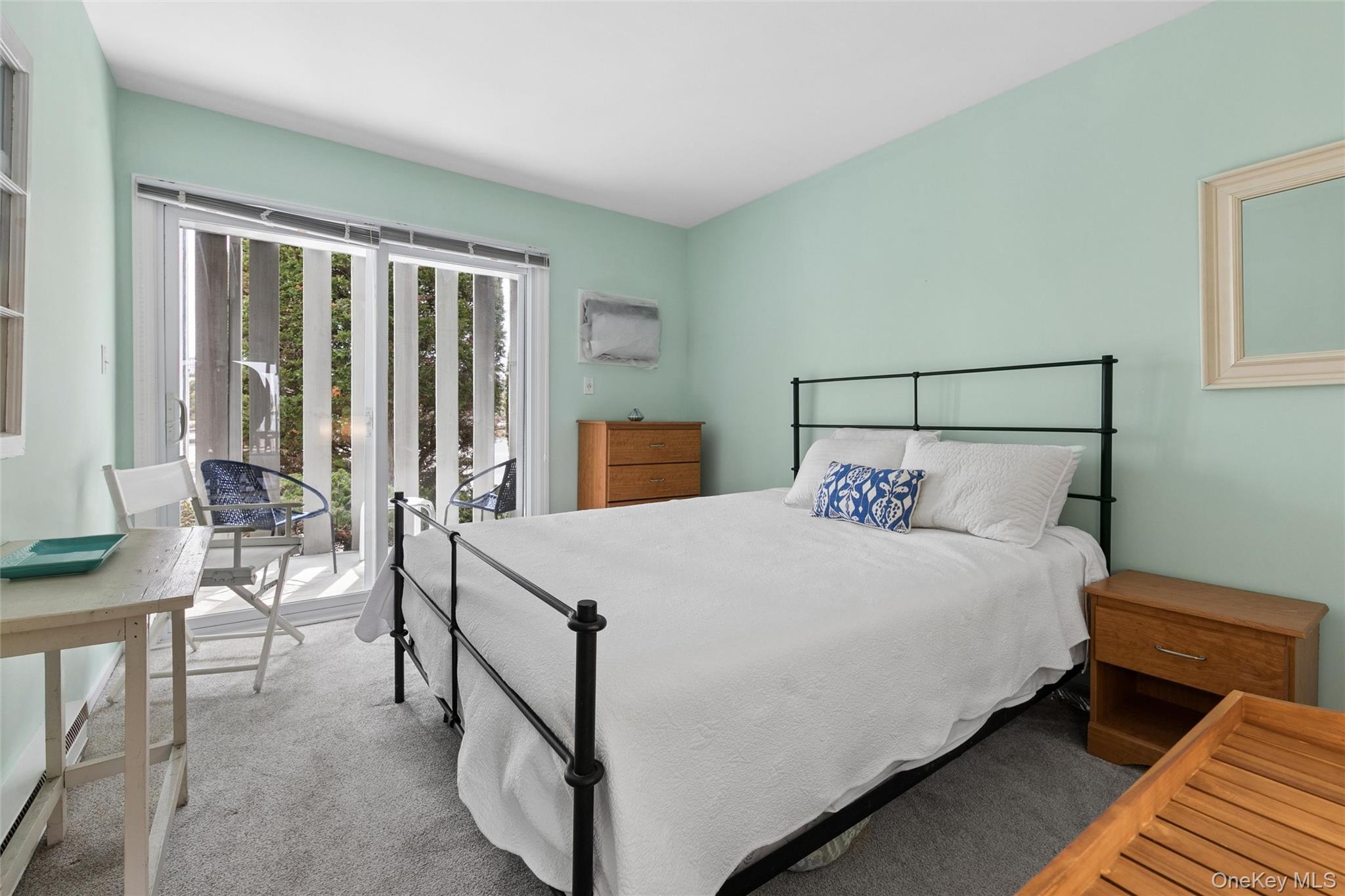 274 Dune Road, Unit 9 Westhampton Beach, NY 11978 - Photo 7 of 13 a bed sitting in a bedroom next to a window