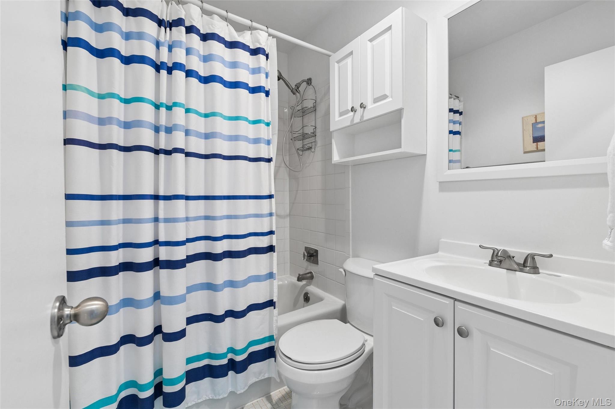 274 Dune Road, Unit 9 Westhampton Beach, NY 11978 - Photo 8 of 13 a bathroom with a sink and a toilet