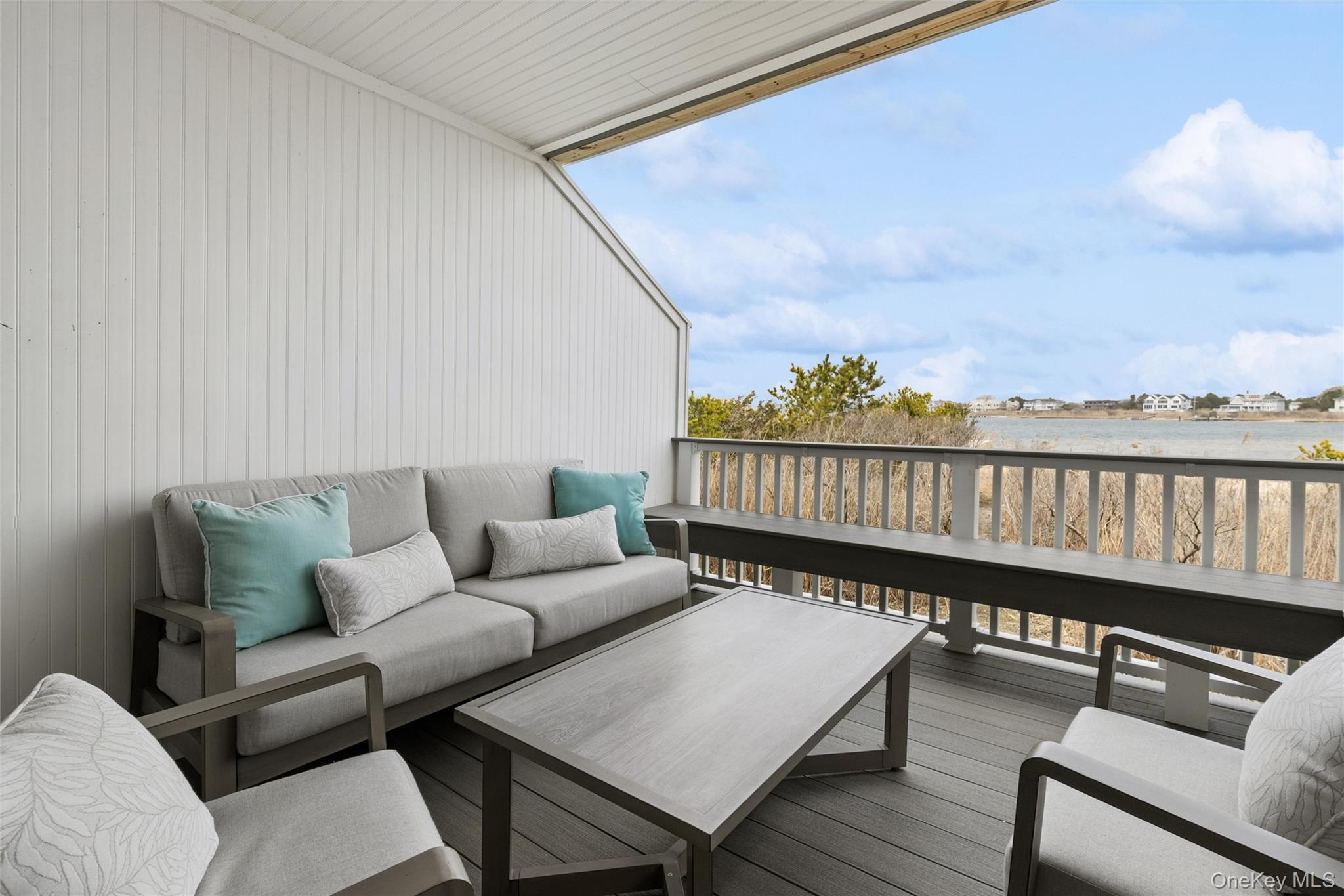274 Dune Road, Unit 9 Westhampton Beach, NY 11978 - Photo 10 of 13 a roof deck with couches and wooden floor