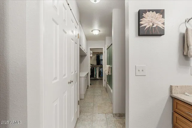 a view of a hallway with paintings on the wall
