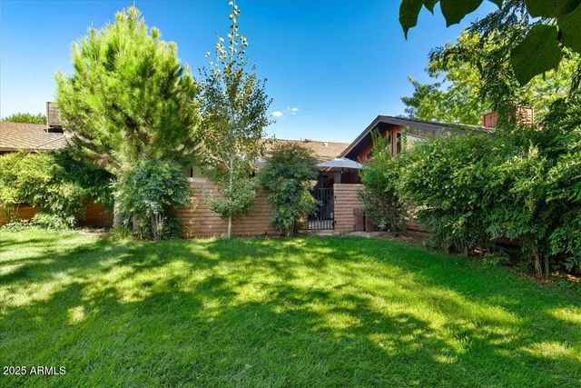 a view of a multi story building with a yard