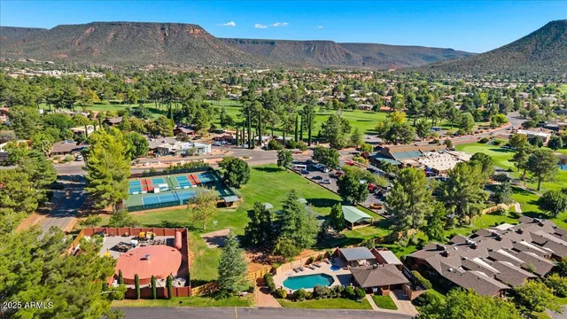 a view of patio with table and chairs and potted plants