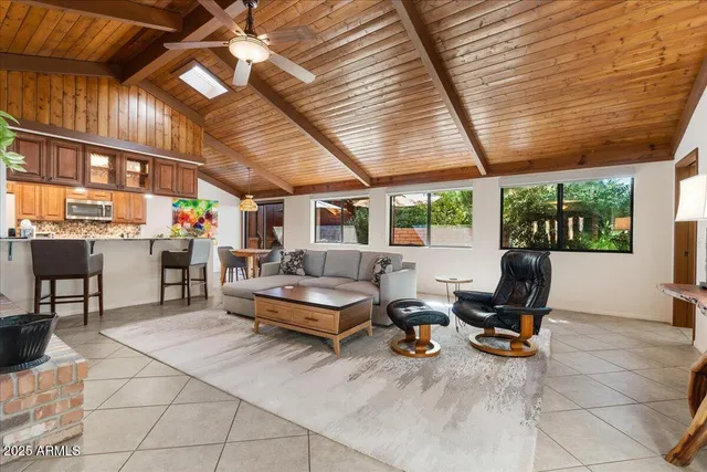 a living room with lots of furniture and a grill