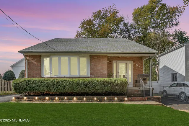 a front view of a house with a garden