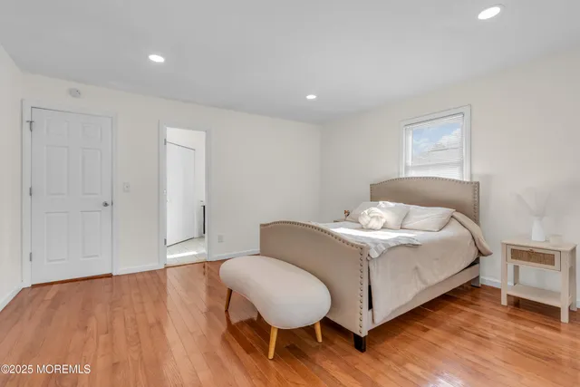 a spacious bedroom with a bed and a chair