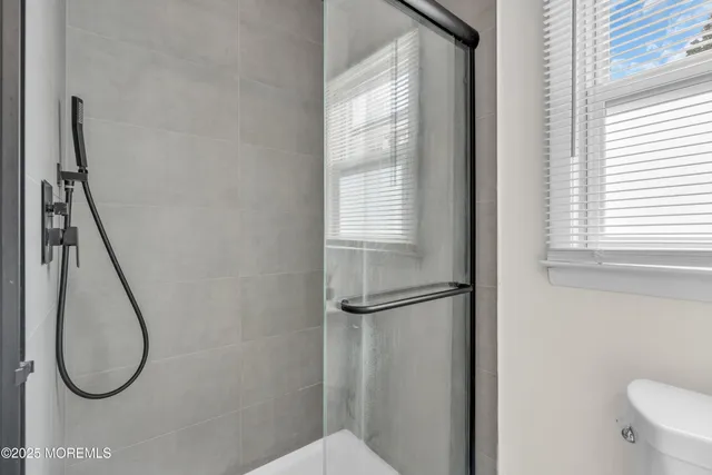 a bathroom with a shower and a window