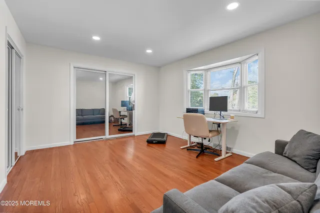 a view of a livingroom with workspace and a window