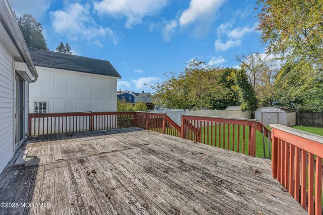 a balcony with wooden floor and fence