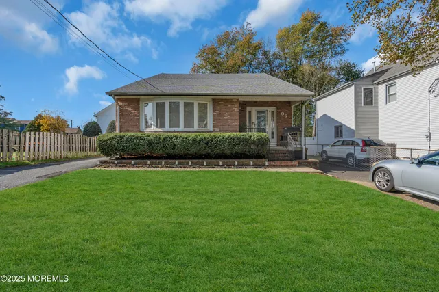 a front view of a house with a garden and plants