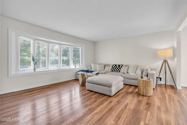 a spacious bedroom with a bed and a wooden floor