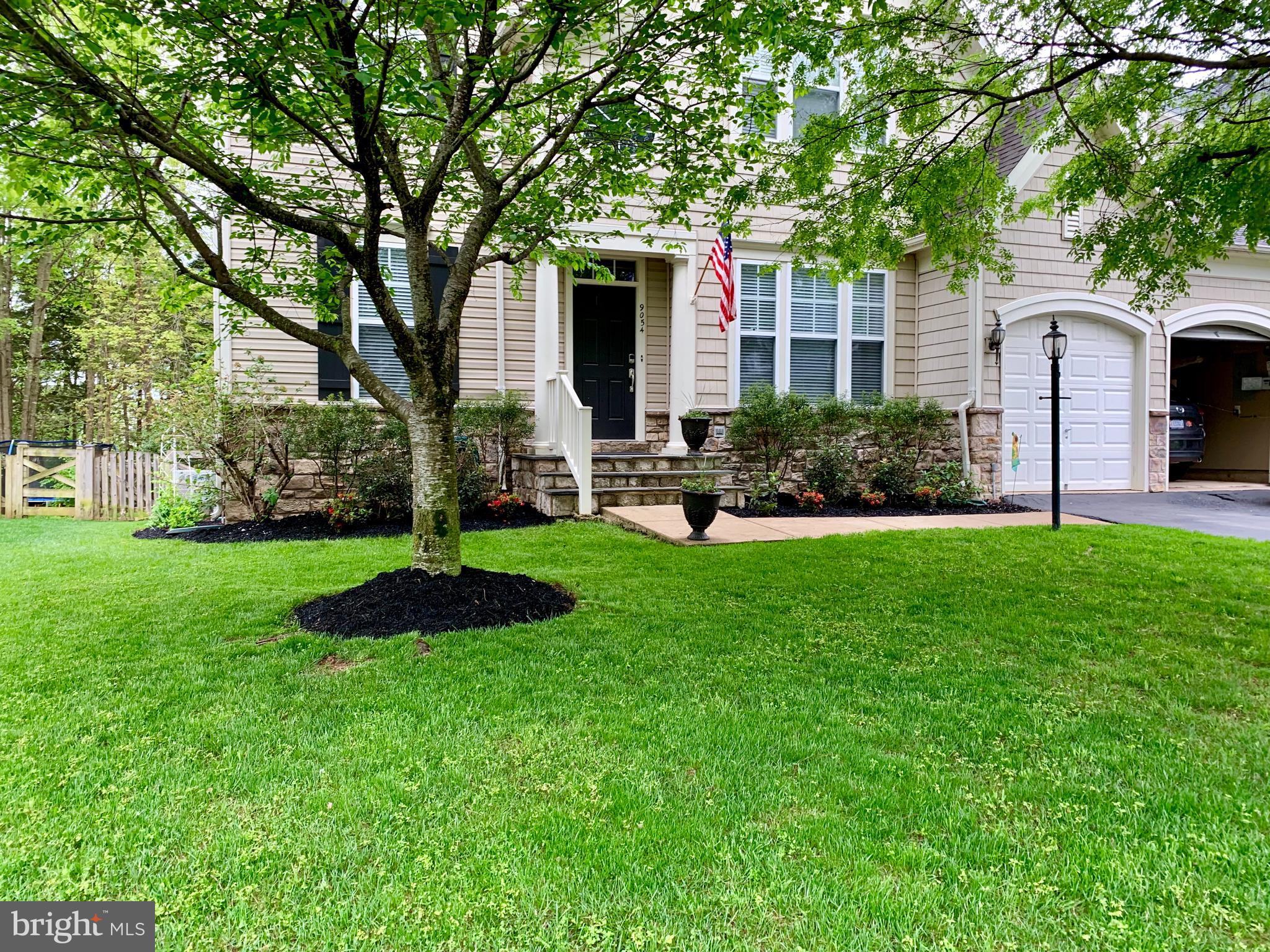 9054 Roaring Spring Loop Bristow, VA 20136 - Photo 2 of 4 a front view of a house with a yard and green space